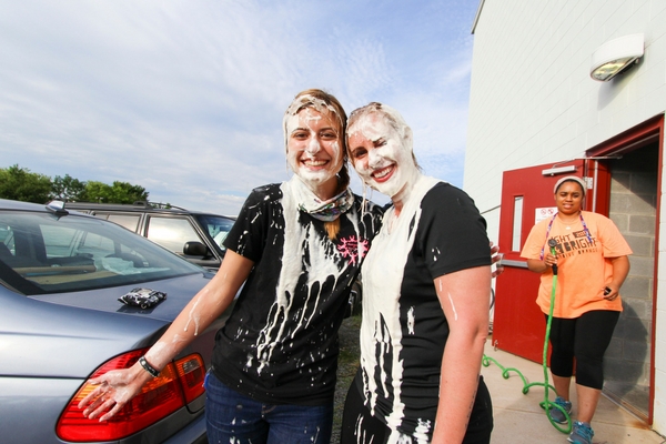 skydiver hugs another jumper after getting pie in the face